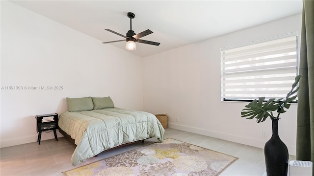 bedroom with ceiling fan, baseboards, and tile patterned floors