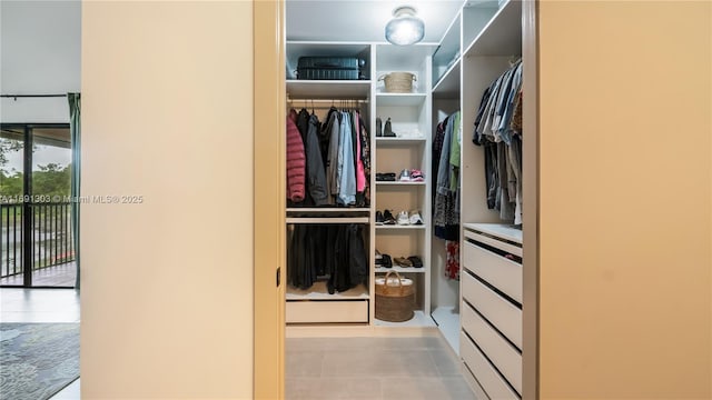 spacious closet with tile patterned floors