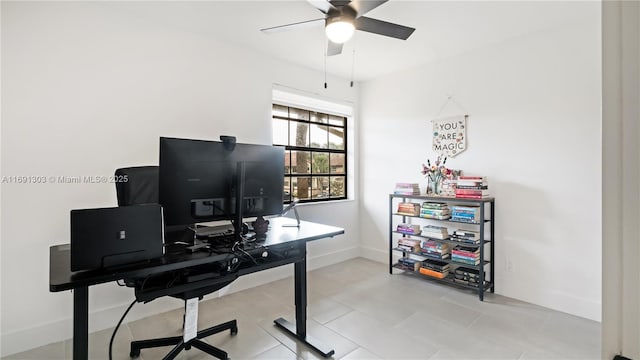 office area featuring light tile patterned floors, baseboards, and a ceiling fan