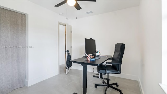 office featuring visible vents, ceiling fan, baseboards, and light tile patterned flooring