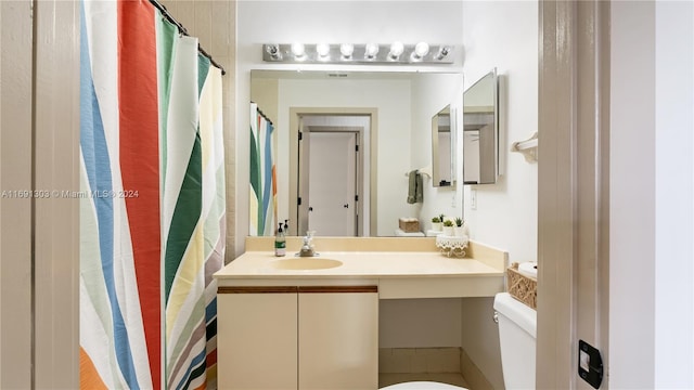 bathroom featuring vanity and toilet