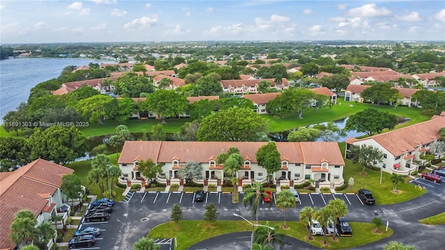 drone / aerial view featuring a water view and a residential view