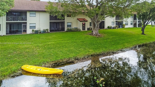 view of yard featuring central AC and a water view