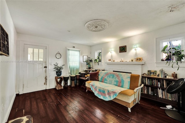 living room with plenty of natural light, hardwood / wood-style floors, and a fireplace
