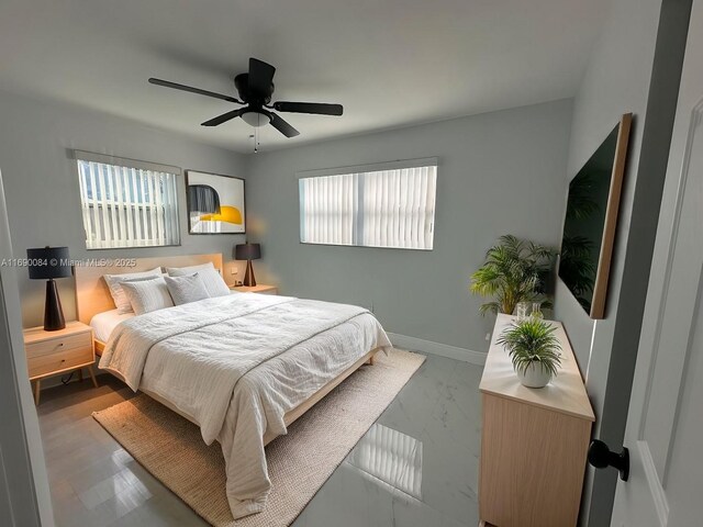 bedroom featuring multiple windows and ceiling fan