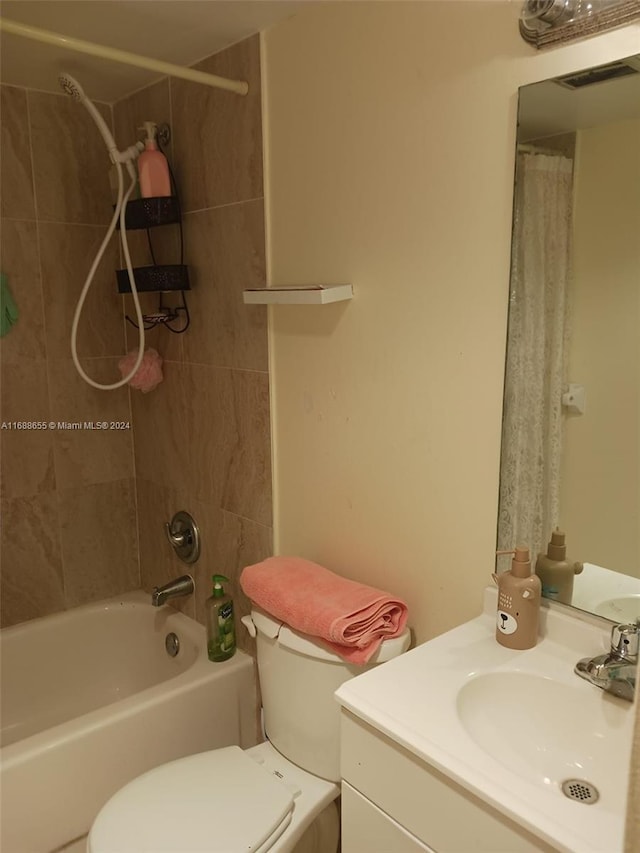 full bathroom with vanity, toilet, and tiled shower / bath