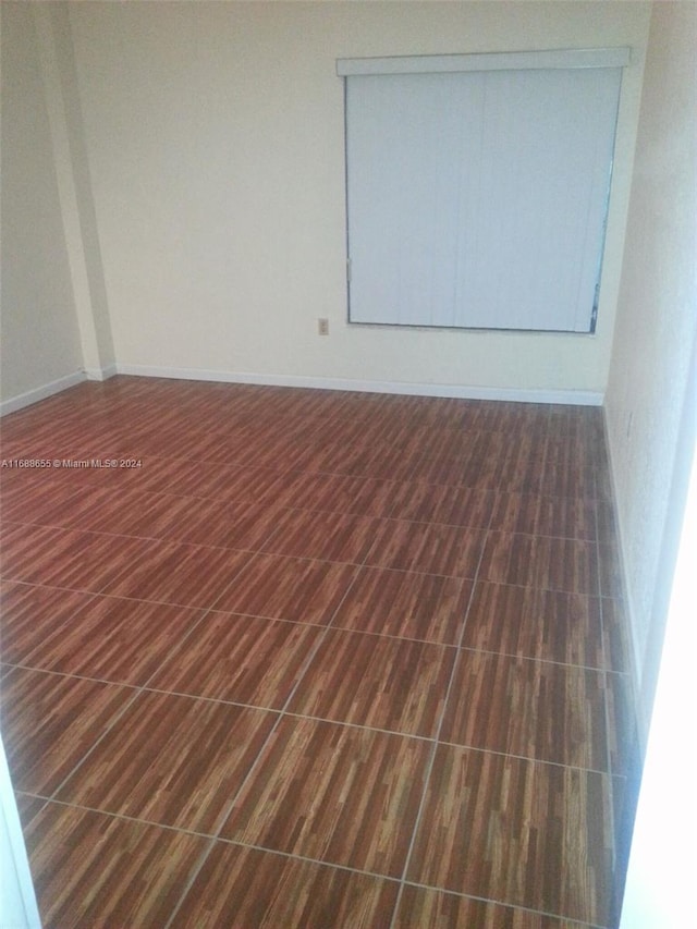 spare room with dark hardwood / wood-style flooring