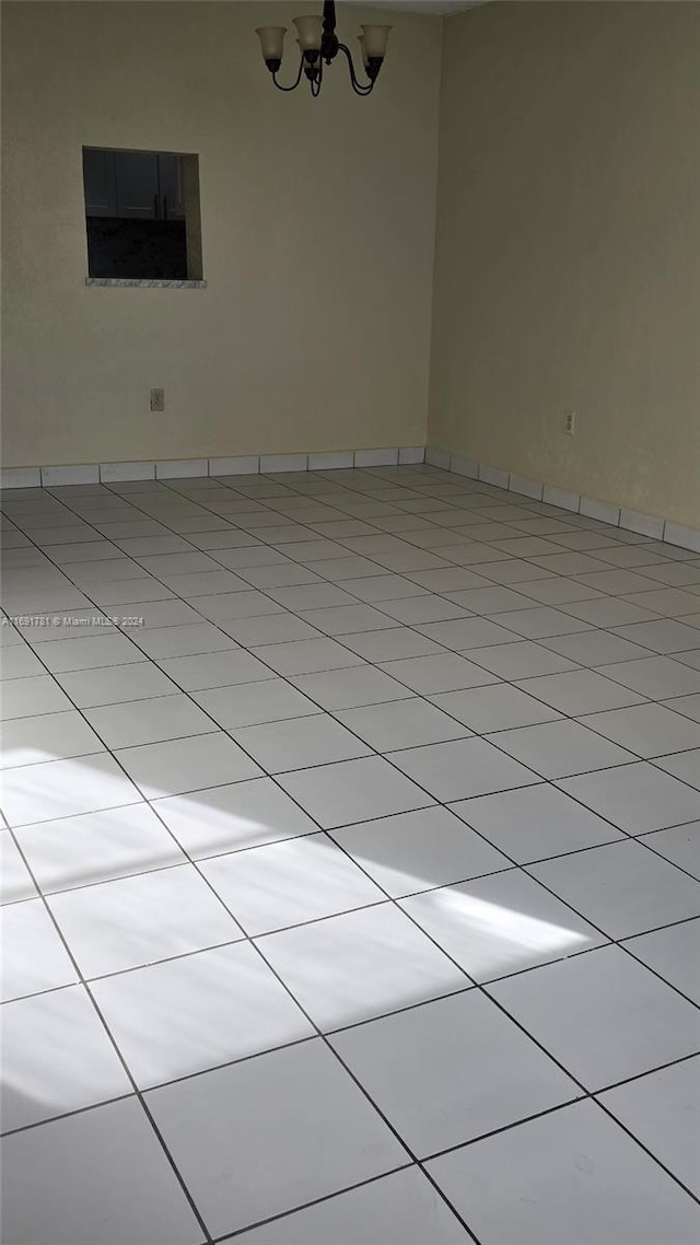 empty room featuring a notable chandelier