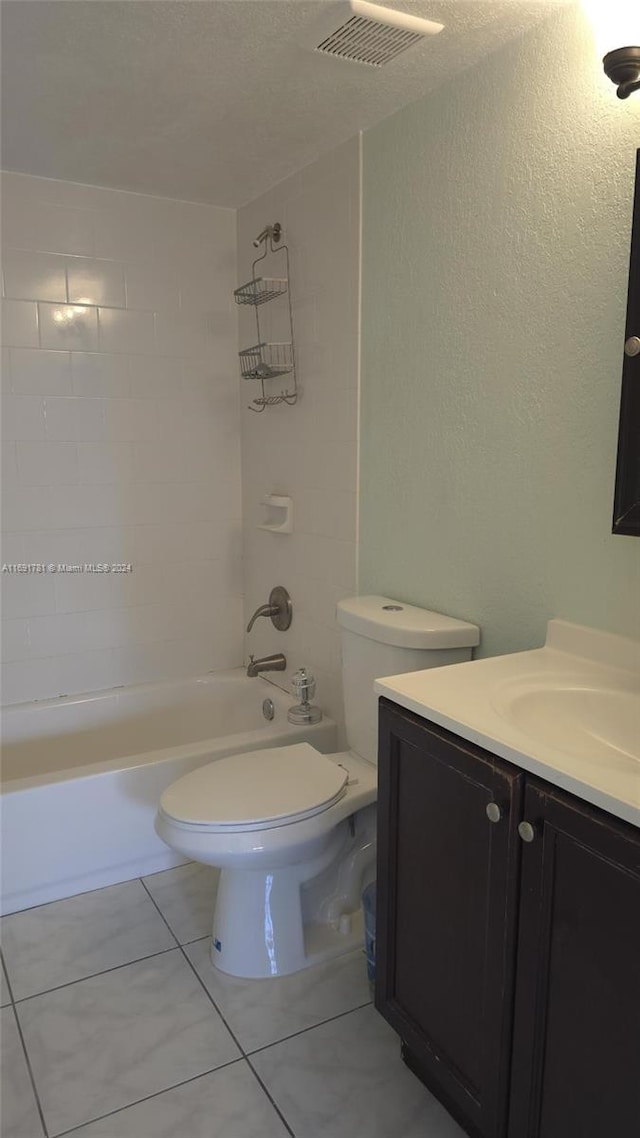 full bathroom with toilet, vanity, and tiled shower / bath