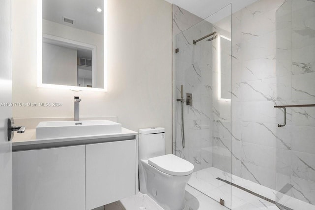 bathroom with an enclosed shower, vanity, and toilet