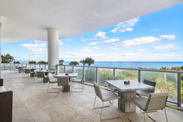 view of patio / terrace featuring a water view and a view of the beach