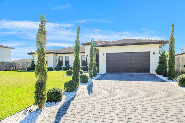 ranch-style home with a front yard and a garage