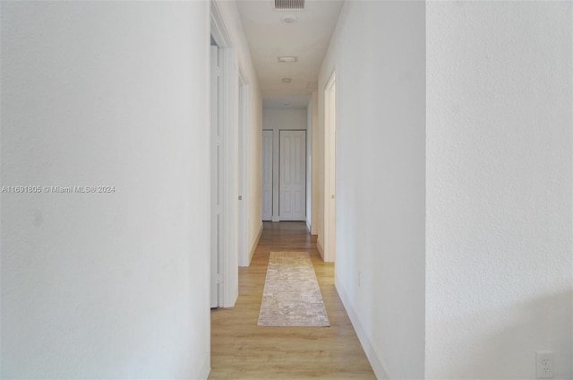 corridor featuring light hardwood / wood-style flooring