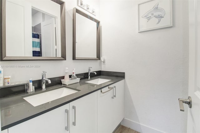 bathroom with vanity and wood-type flooring