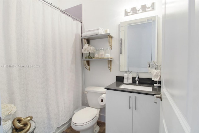 bathroom with vanity, toilet, and walk in shower