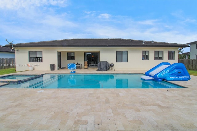 view of swimming pool with an in ground hot tub and a patio