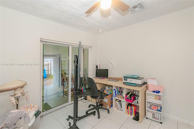 tiled home office with a textured ceiling and ceiling fan