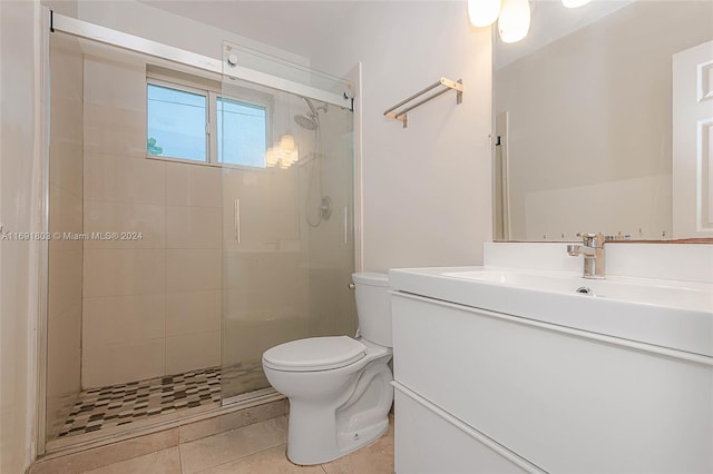 bathroom featuring vanity, tile patterned flooring, toilet, and an enclosed shower