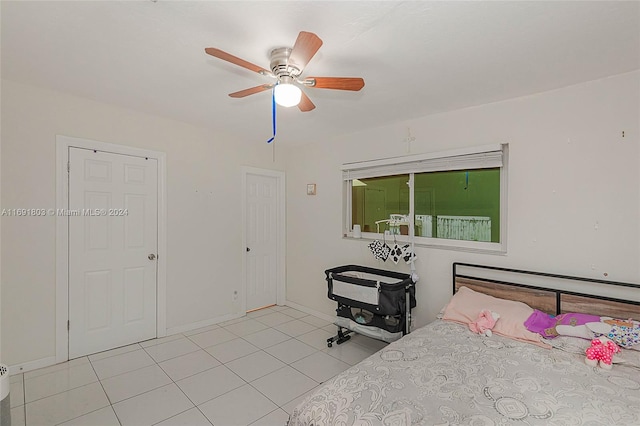 tiled bedroom with ceiling fan