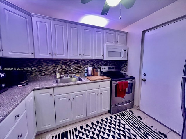 kitchen with tasteful backsplash, white cabinetry, sink, electric range, and ceiling fan