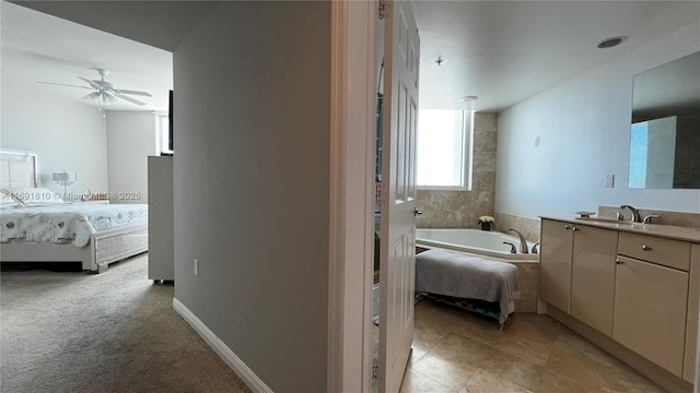 bathroom with vanity, a bathing tub, and ceiling fan