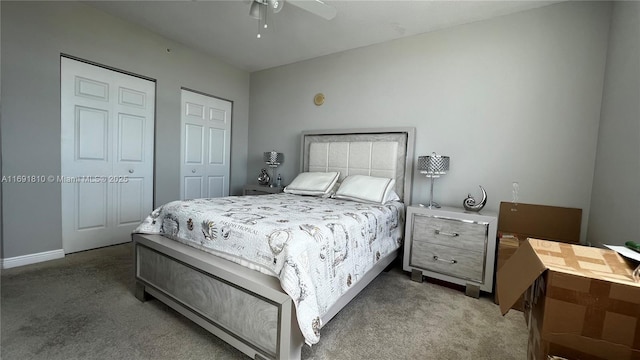 carpeted bedroom featuring ceiling fan and multiple closets