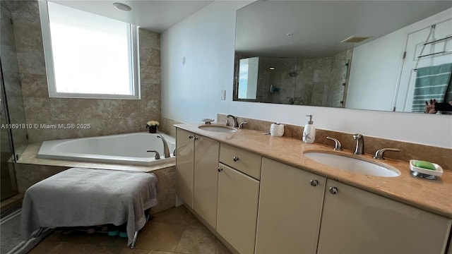 bathroom with tile patterned floors, vanity, and independent shower and bath