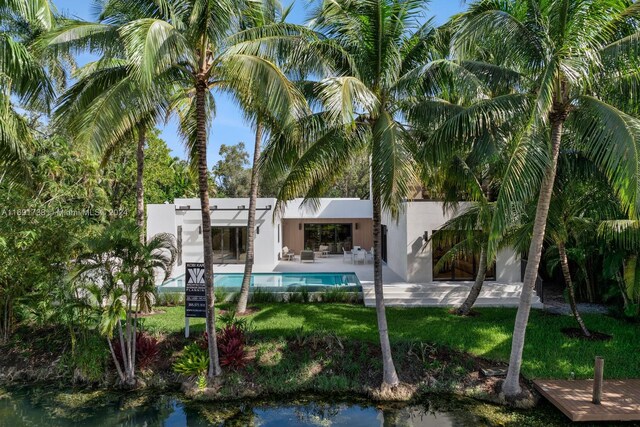 11150 Griffing Blvd, Biscayne Park, FL 33161 - rear view of property with stucco siding, an outdoor pool, and a patio area