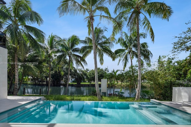 view of swimming pool featuring a water view