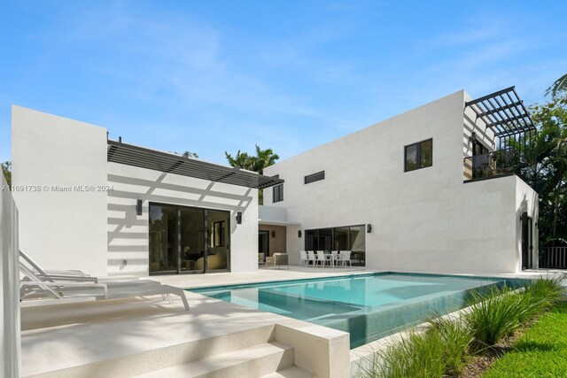 11150 Griffing Blvd, Biscayne Park, FL 33161 - back of house featuring a balcony, a patio, an infinity pool, and stucco siding