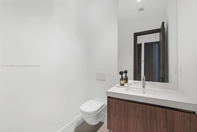 bathroom featuring toilet and vanity