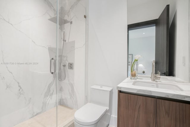 bathroom featuring an enclosed shower, vanity, and toilet