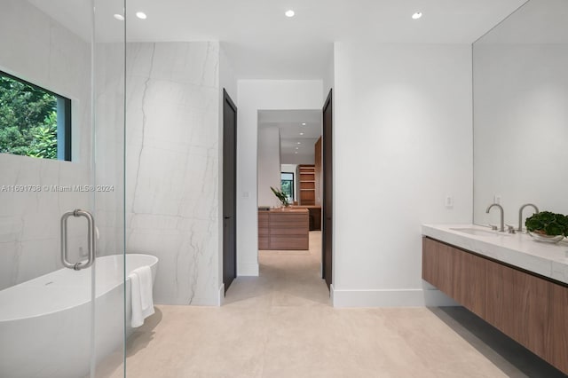 bathroom featuring tile walls, shower with separate bathtub, and vanity