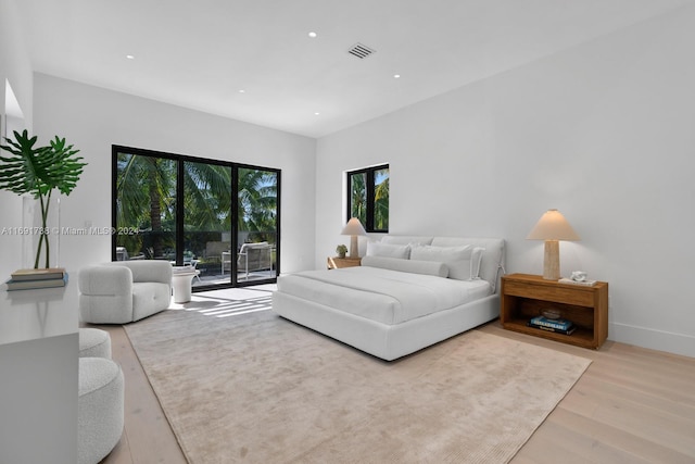 bedroom featuring light wood-type flooring and access to outside