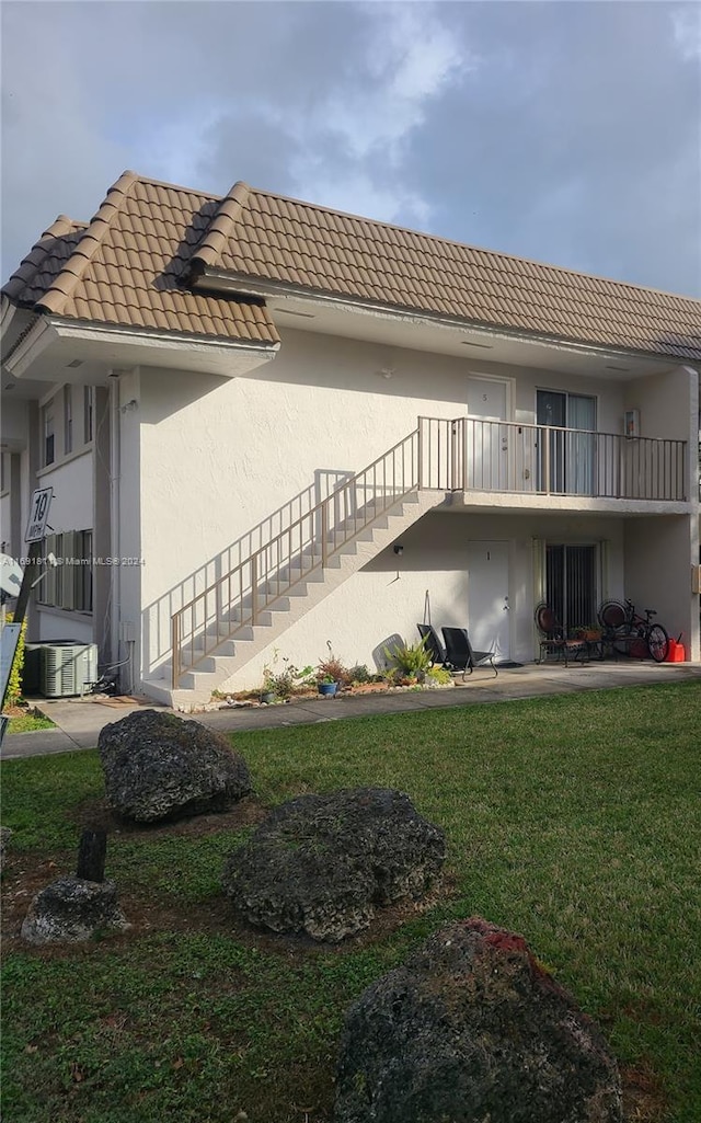 view of home's exterior with a lawn, a patio area, and central AC unit