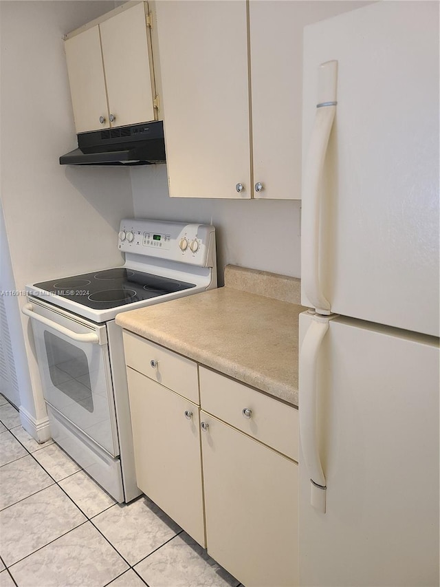 kitchen with light tile patterned floors and white appliances