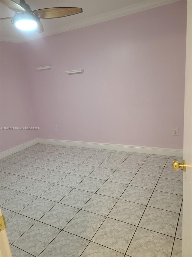 unfurnished room with ceiling fan, ornamental molding, and light tile patterned floors