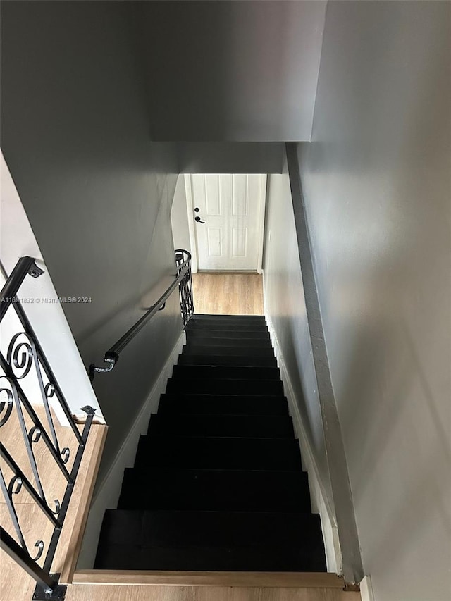 stairs with wood-type flooring