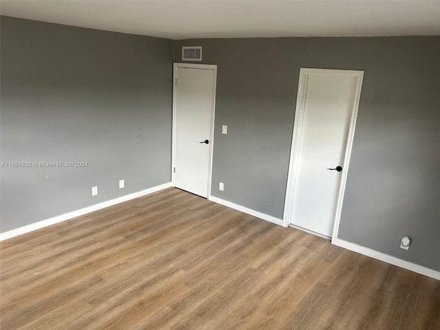 empty room with light hardwood / wood-style flooring