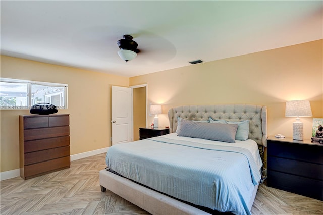 bedroom with ceiling fan and light parquet flooring