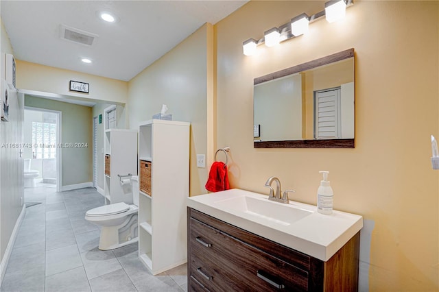 bathroom featuring tile patterned flooring, vanity, and toilet