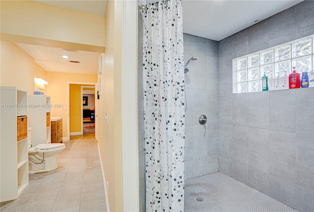 bathroom with toilet, vanity, a shower with shower curtain, and tile patterned floors