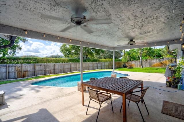 view of swimming pool with ceiling fan and a patio area