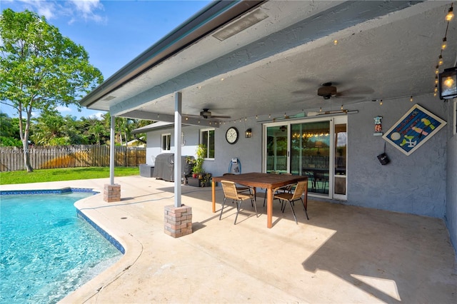 view of swimming pool featuring ceiling fan and a patio area