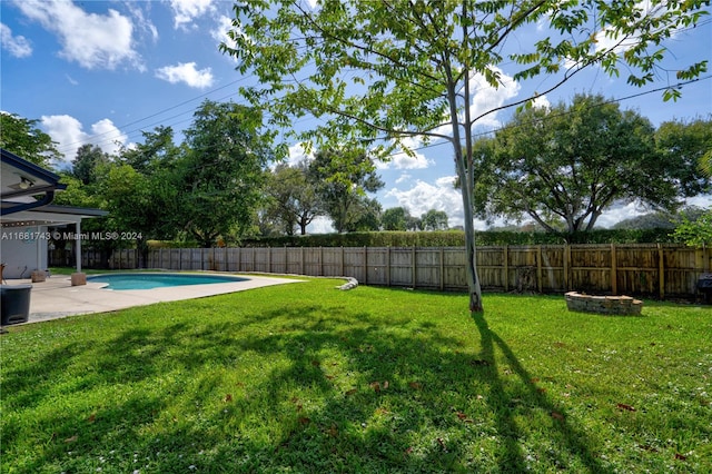 view of yard featuring a fenced in pool and a patio area