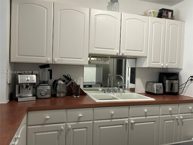 1395 NE 167th St Unit 315, Miami, FL 33162 - kitchen featuring a sink, dark countertops, and white cabinets