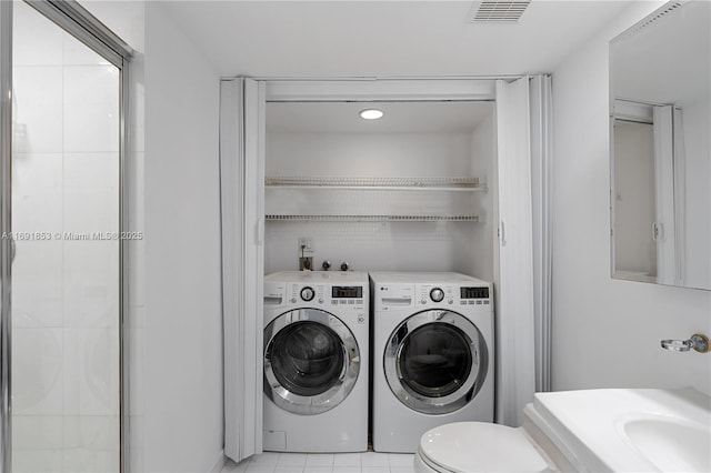 laundry area featuring independent washer and dryer and sink