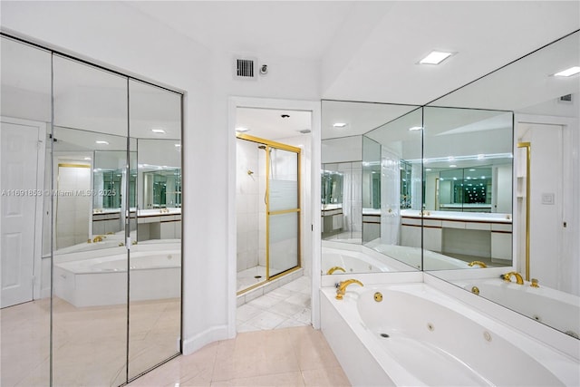 bathroom featuring vanity, tile patterned flooring, and plus walk in shower