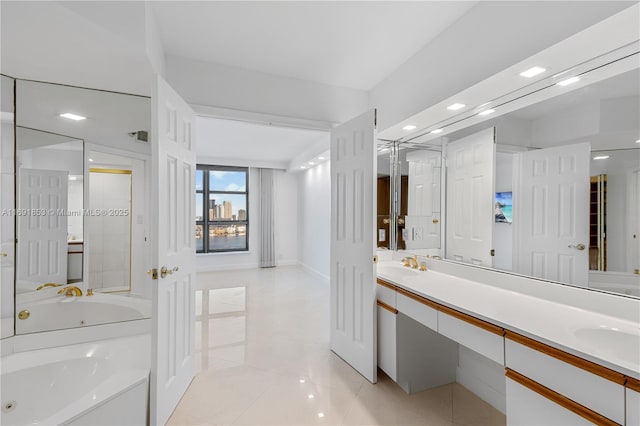 bathroom featuring vanity, tile patterned floors, and a bathtub