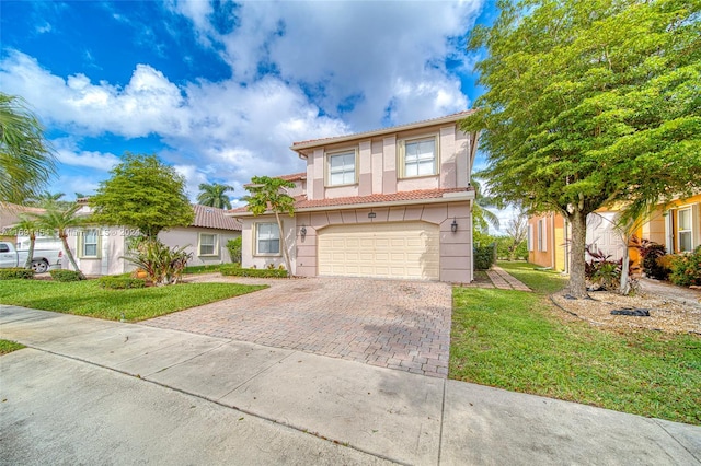 view of front of home with a garage and a front lawn